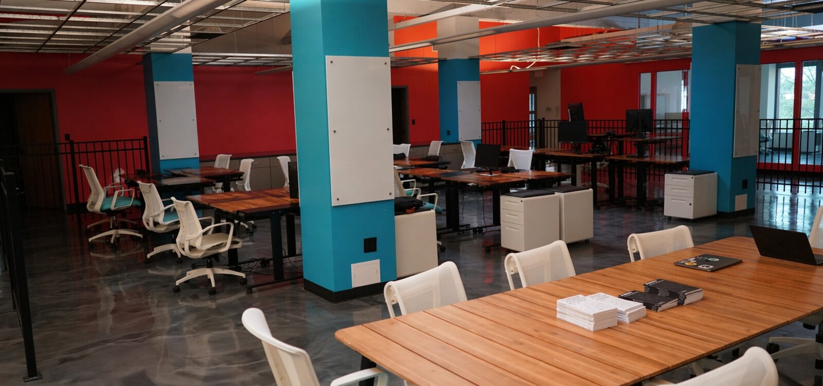 Open coworking floor with tables and chairs