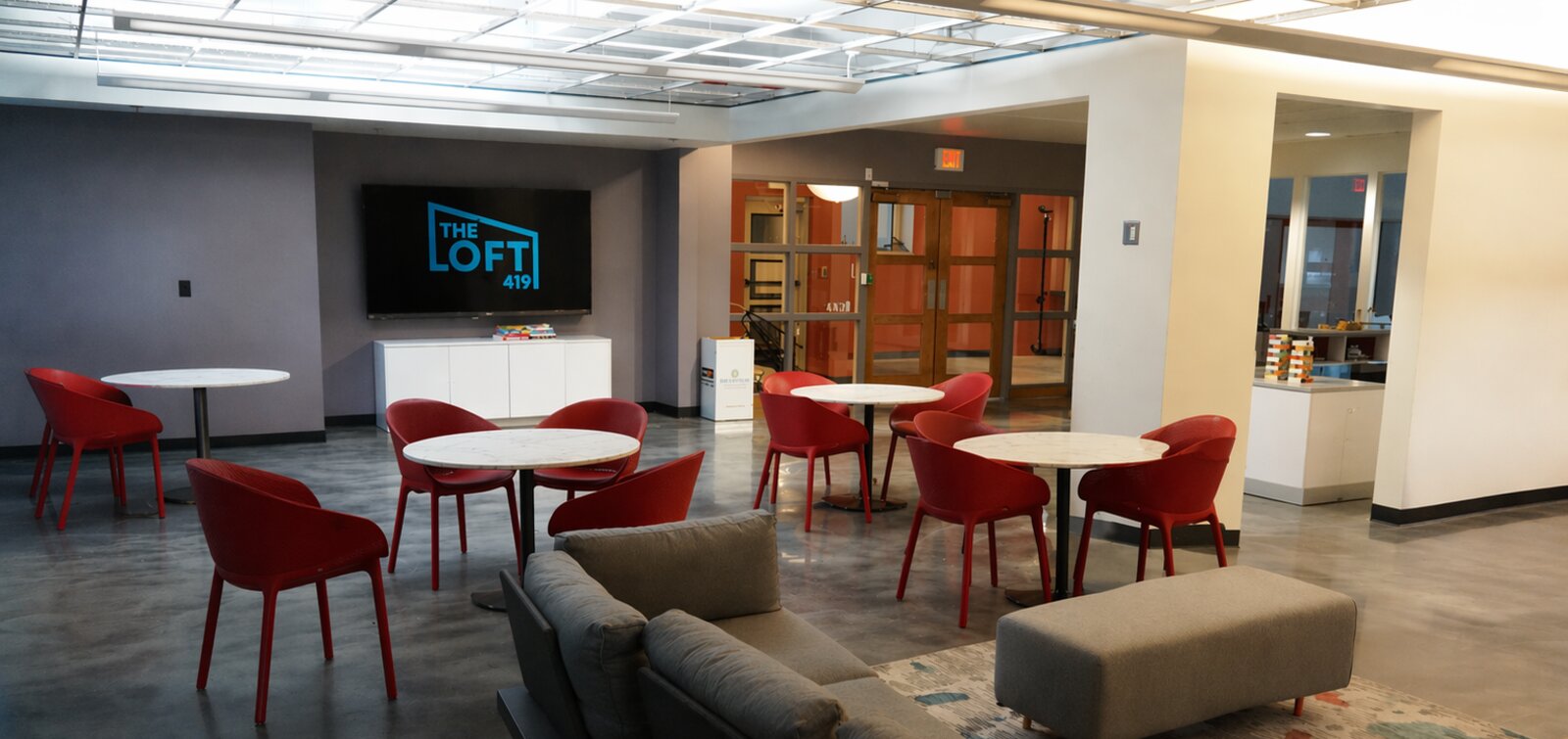 The Loft 419 main space arranged with tables and chairs